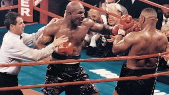 Evander Holyfield fights Mike Tyson in their first match on November 9, 1996.